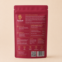 The back of a pink Ancient Extracts Tremella Mushroom supplement pouch, featuring detailed text, usage instructions, ingredients, and a barcode, set against a solid beige background.